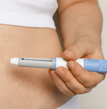 Close-up of a person administering a GLP-1 weight loss injection