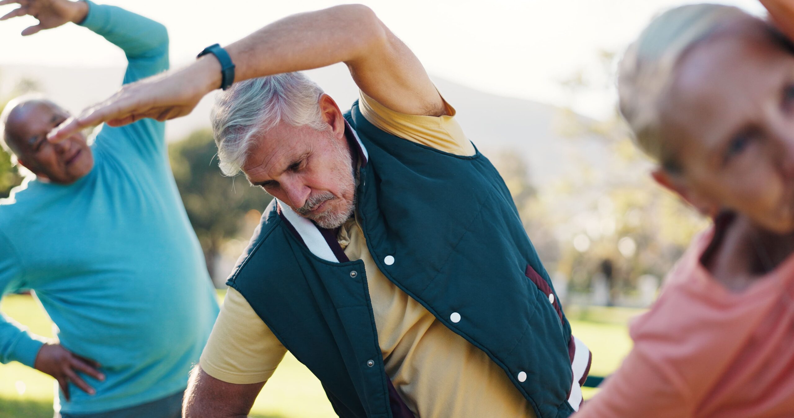 Active adults stretching outdoors