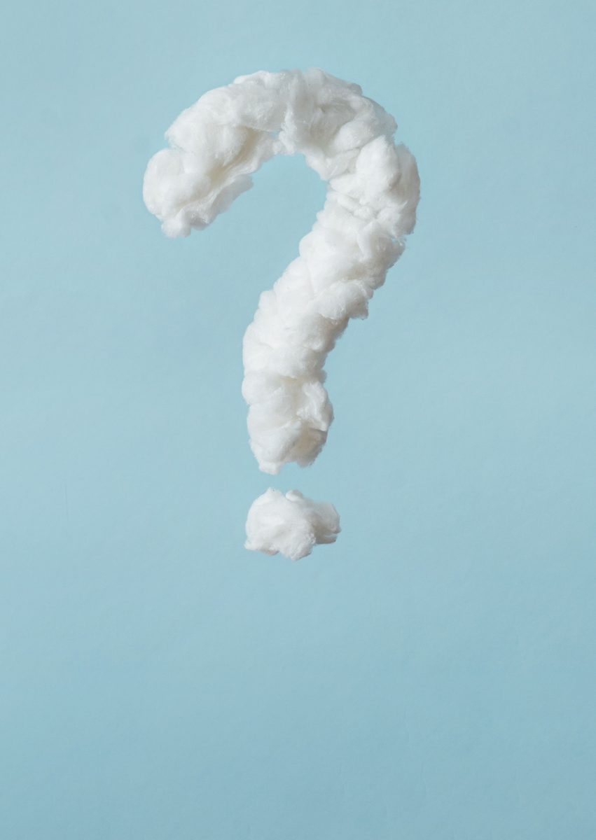 Question mark made of cotton on a light blue background