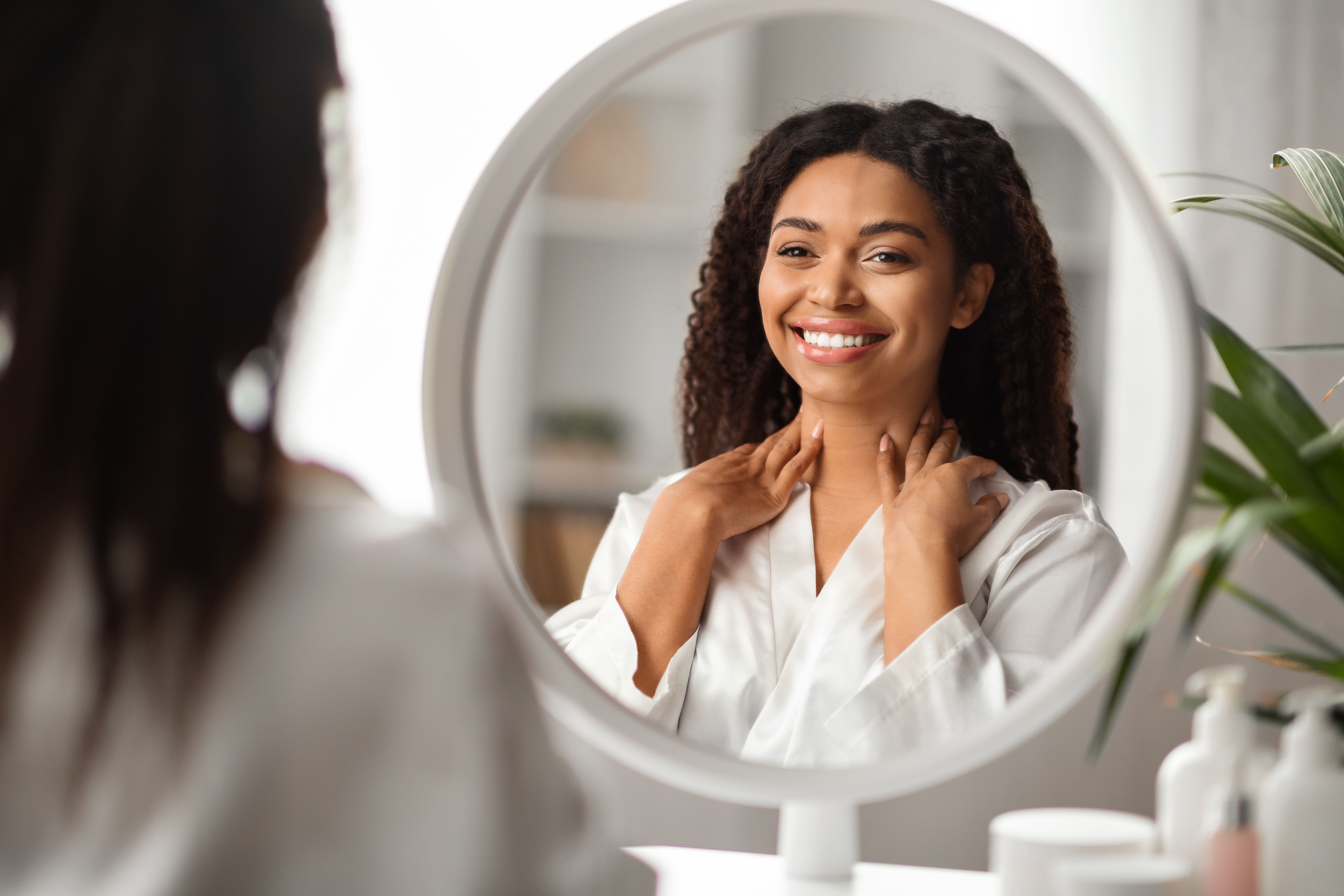 Woman smiling at herself in the mirror